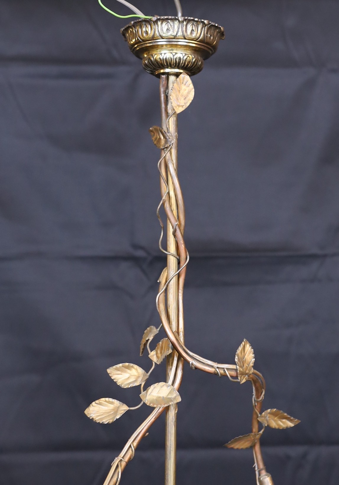 A 1920s French gilt bronze and wrought iron ceiling light with putto and rose motifs, drop 71cm. width 44cm